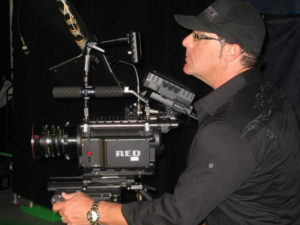 Bob checking a RED camera before directing a music video.