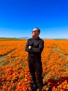Bob Bekian standing in California Poppy Field